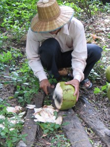 Pastor Soy opening a coconut (that's a sharp machete!).
